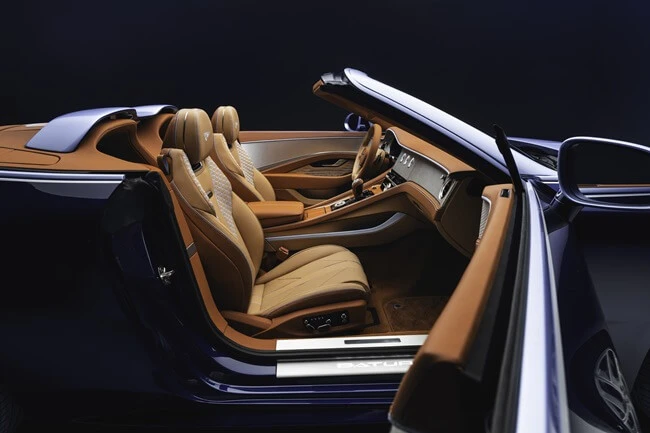 Curated automotive interior with warm autumnal tan and caramel leather, featuring the bespoke Airbridge in Breslow Blue.