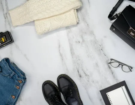 Flat lay of modular clothing and sustainable accessories highlighting 2026 fashion trends including intelligent minimalism