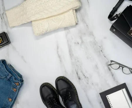 Flat lay of modular clothing and sustainable accessories highlighting 2026 fashion trends including intelligent minimalism