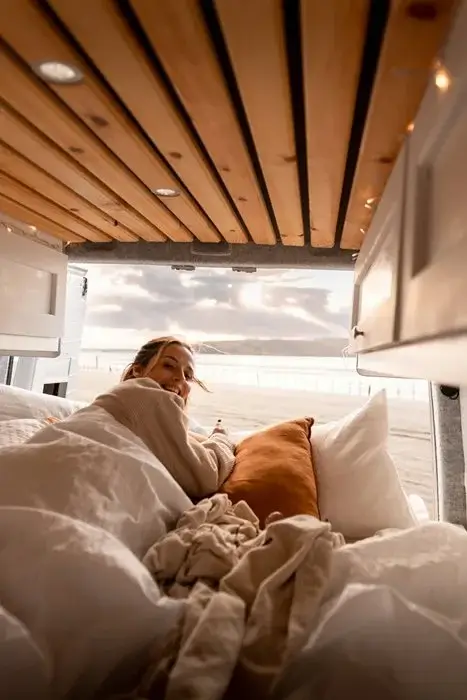Compact-van-interior-layout-showing-sleeping-area-kitchen-and-storage-zones Compact van interior layout showing sleeping area, kitchen and storage zones