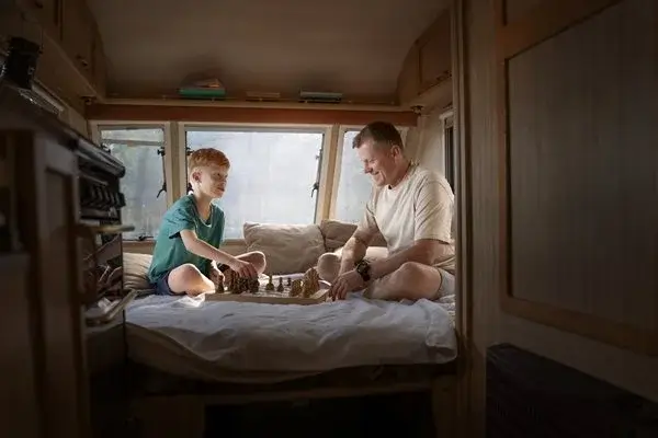 Scandinavian-style-van-interior-with-light-wood-panels-and-white-linen-bedding Scandinavian-style van interior with light wood panels and white linen bedding